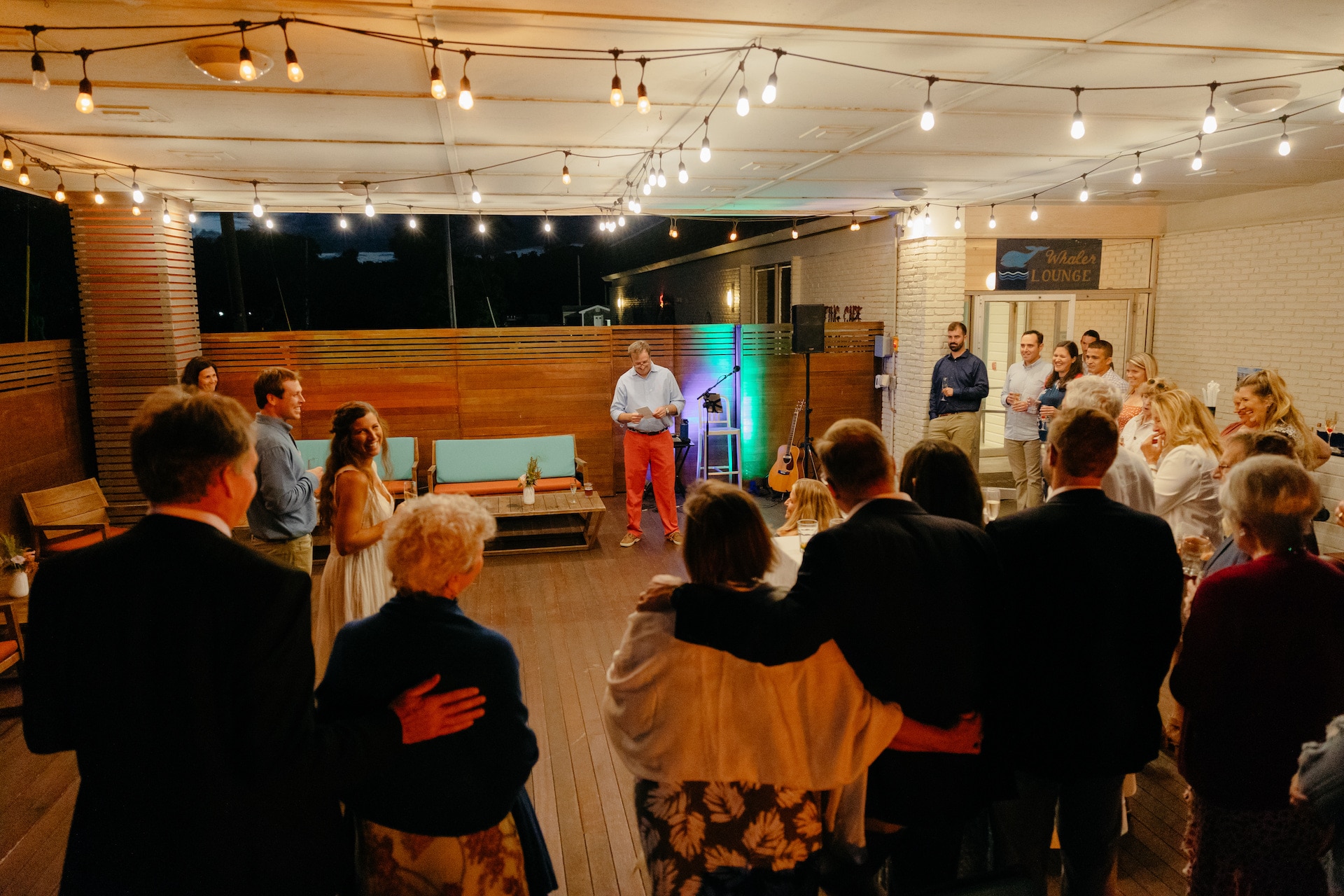 A group of people gathered in a lounge area at night