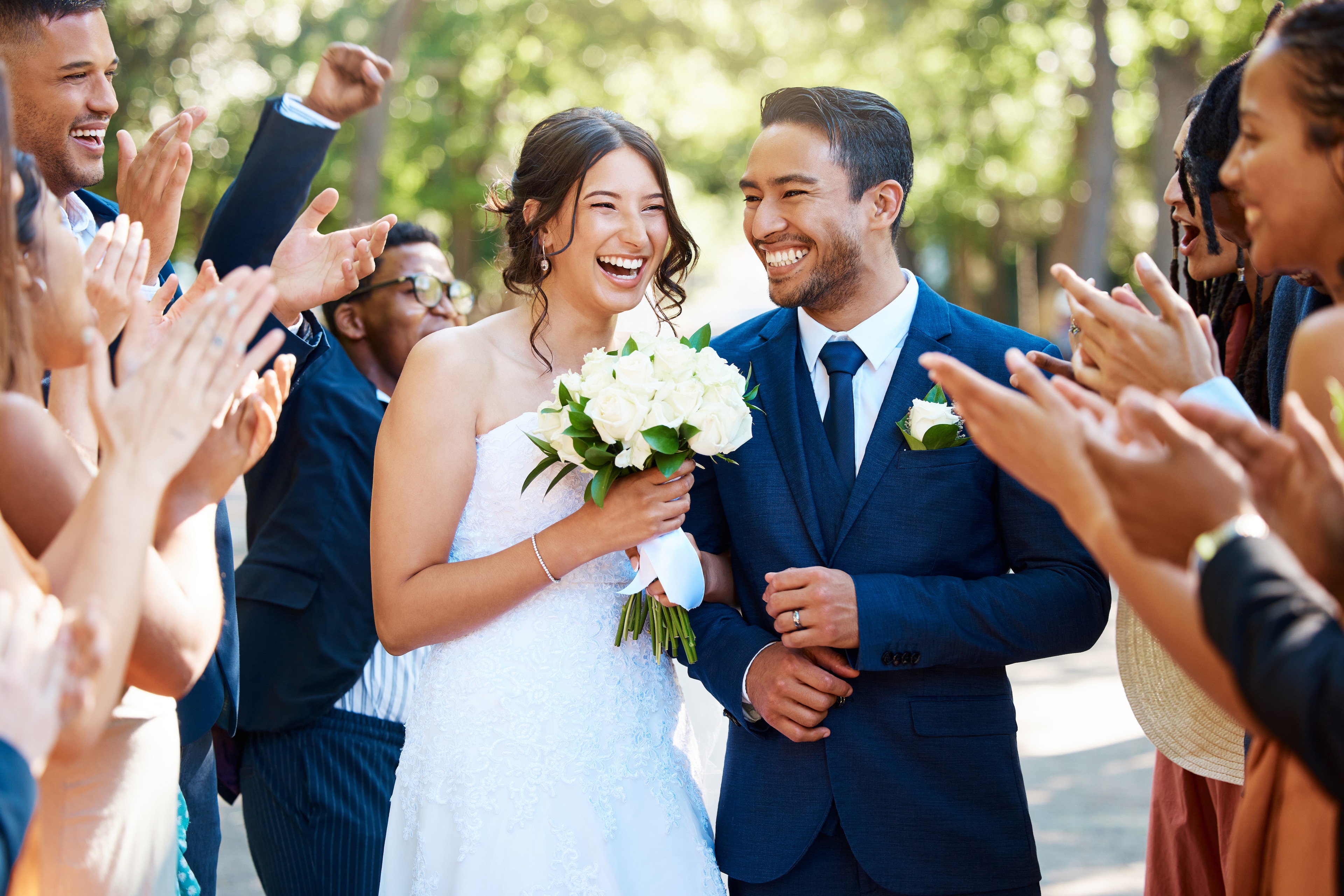 The bride and groom smile as they pose with their wedding party