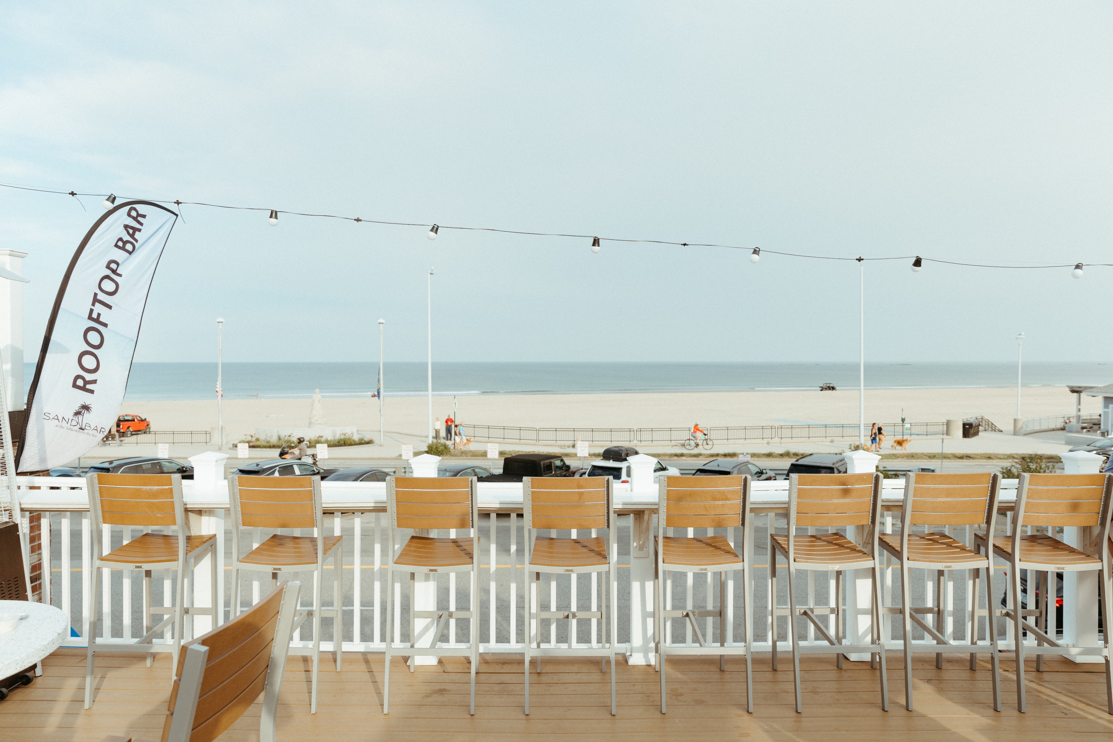 A rooftop bar with a view of the beach and ocean