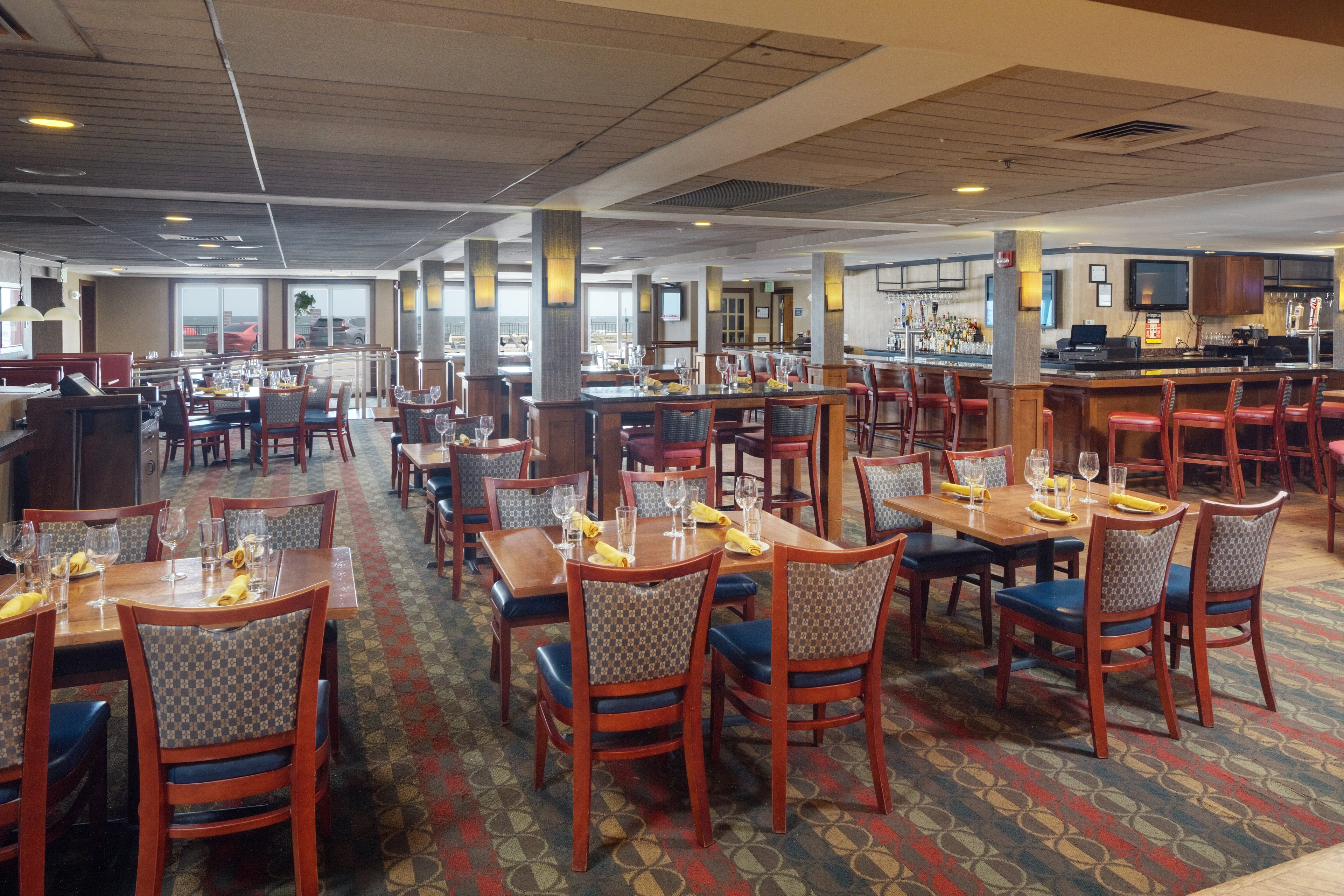 a dining area with tables and chairs set for a meal