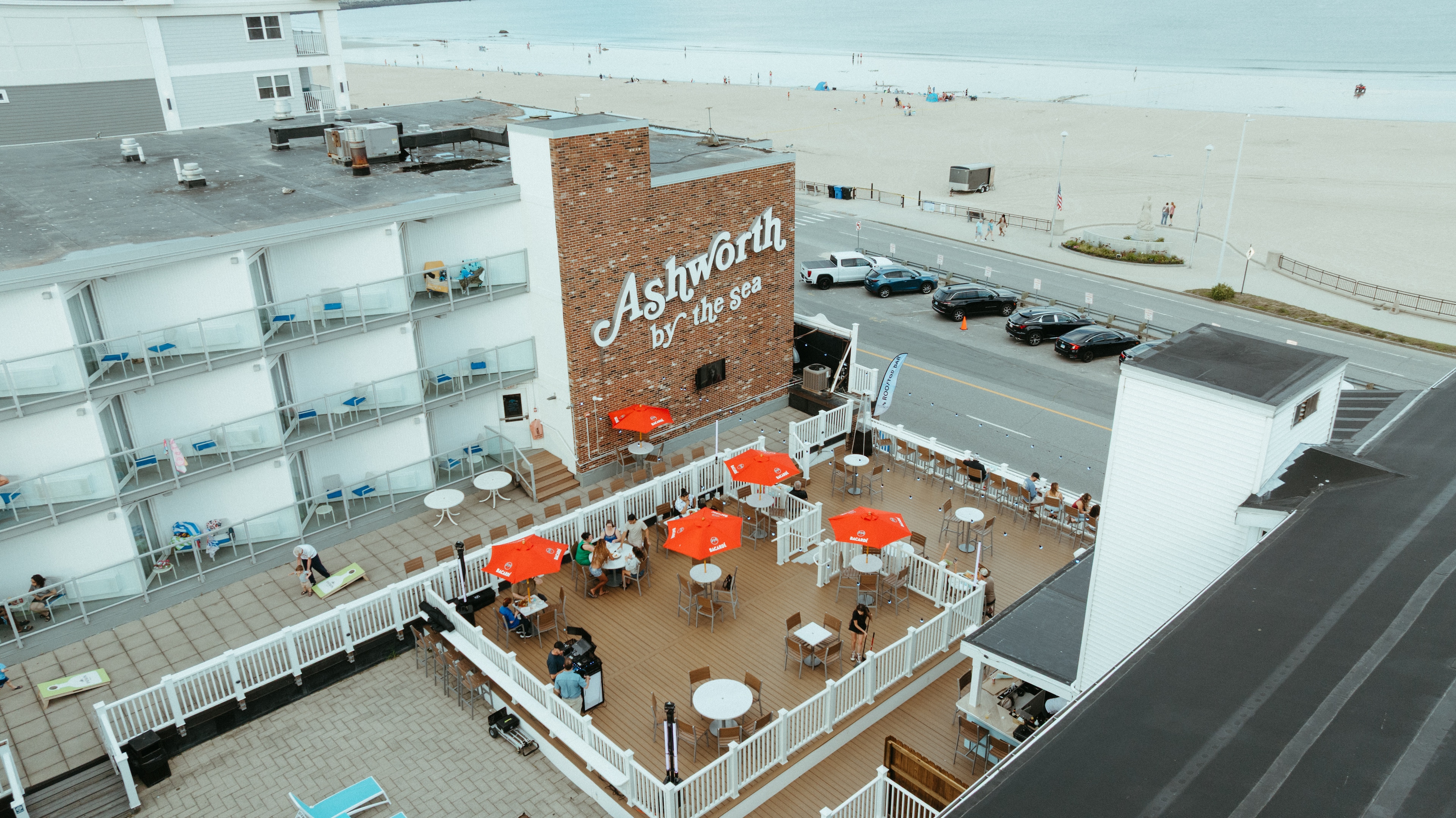 An aerial view of a beachfront hotel with a patio area.