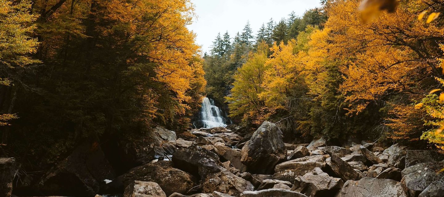 Autumn scenery featuring a waterfall near The Centennial Hotel in Concord, NH.
