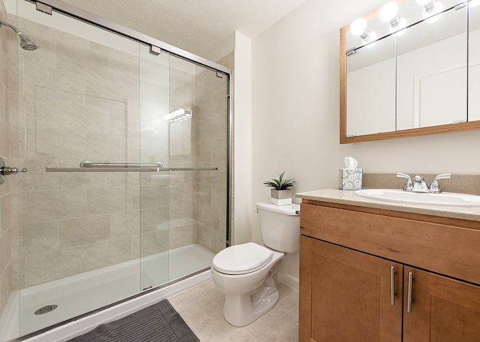 A bathroom with a shower stall and toilet at California Apartments in Absecon, New Jersey