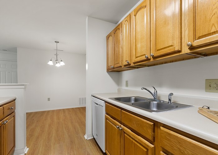 A kitchen with a sink, dishwasher and refrigerator at California Apartments in Absecon, New Jersey