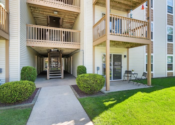 The front entrance to an apartment complex with a patio and balcony at California Apartments in Absecon, New Jersey