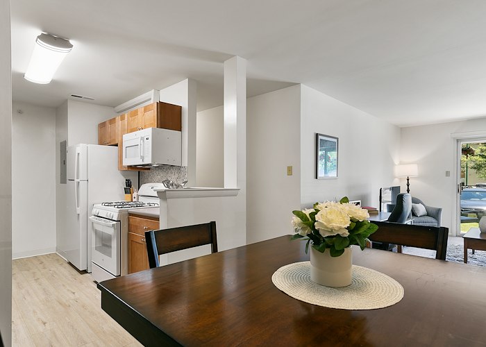 A kitchen and dining room with a table and chairs at California Apartments in Absecon, New Jersey