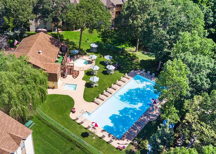 An aerial view of a pool and lawn at a resort at California Apartments in Absecon, New Jersey