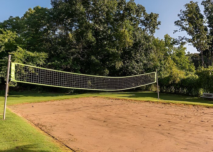 A volleyball net sits in the middle of a grassy field, Country Club Apartments, Huntington, West Virginia