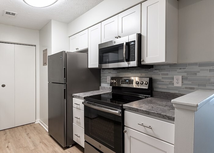 A kitchen with stainless steel appliances and a refrigerator, Country Club Apartments, Huntington, West Virginia