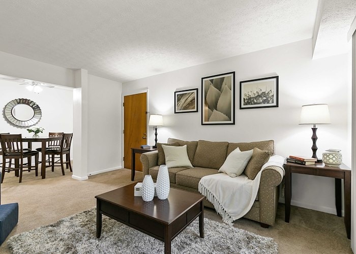 A living room with a couch, coffee table and dining area, Country Club Apartments, Huntington, West Virginia