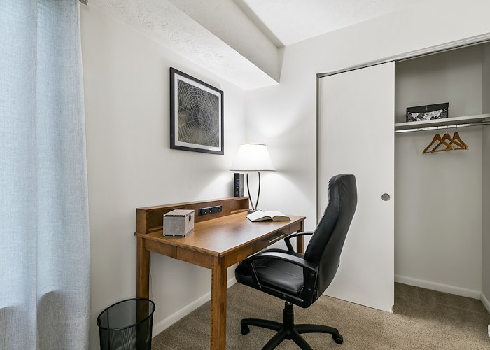 A small bedroom with a desk and chair, Country Club Apartments, Huntington, West Virginia