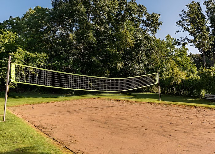 A volleyball net sits in the middle of a grassy field, Country Club Apartments, Huntington, West Virginia