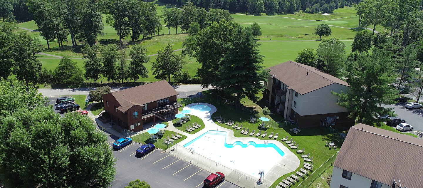 An aerial view of a pool and apartment complex at Country Club Apartments in Huntington, West Virginia