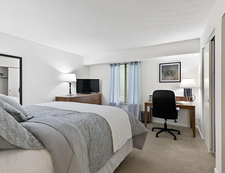 A bedroom with a bed, dresser and television, Country Club Apartments, Huntington, West Virginia