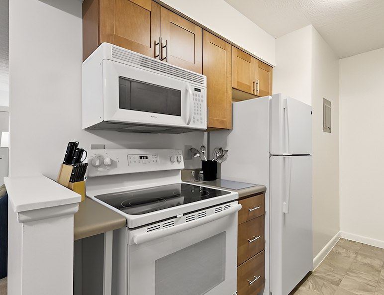 A kitchen with stainless steel appliances and a refrigerator, Country Club Apartments, Huntington, West Virginia
