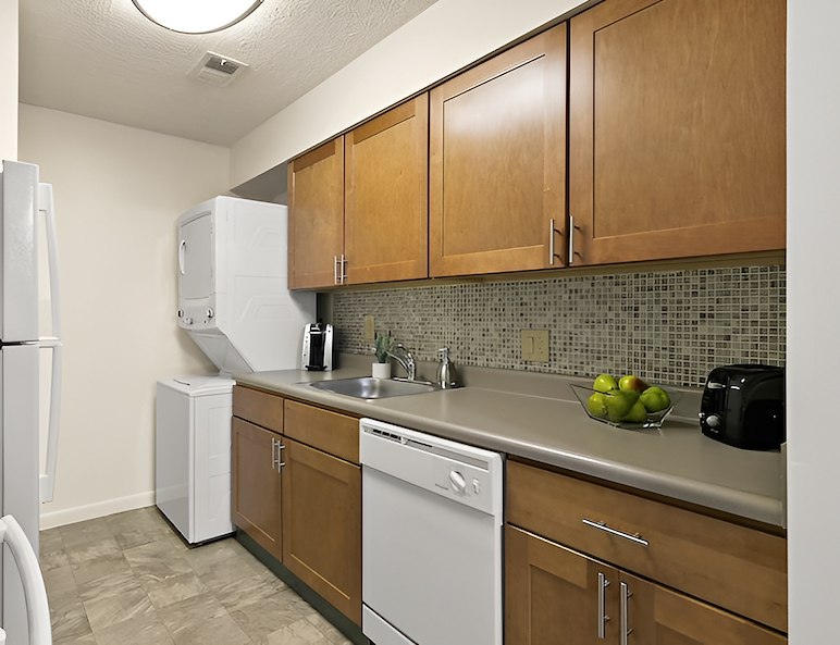 A kitchen with white appliances and wood cabinets, Country Club Apartments, Huntington, West Virginia
