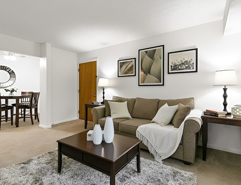 A living room with a couch, coffee table and dining area, Country Club Apartments, Huntington, West Virginia