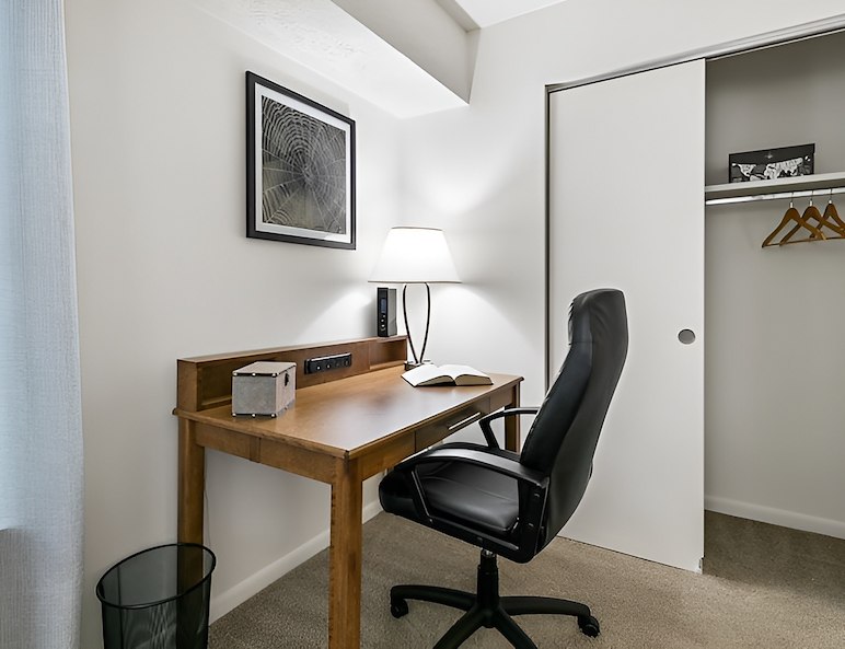 A small bedroom with a desk and chair, Country Club Apartments, Huntington, West Virginia
