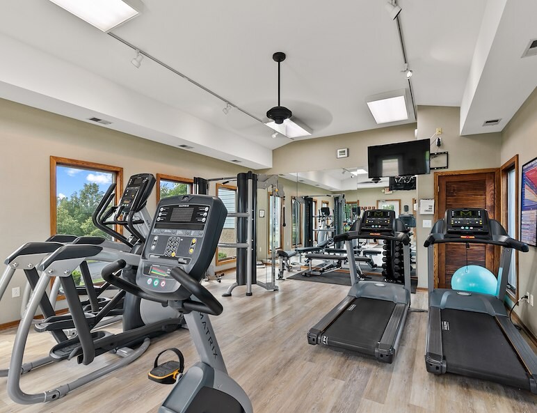 a gym with treadmills and exercise equipment