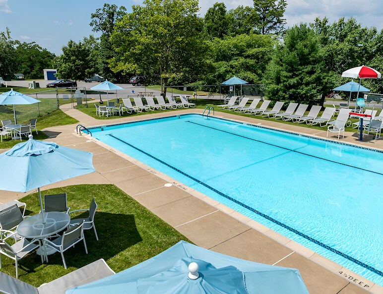 Pool with chairs at East Mountain apartments