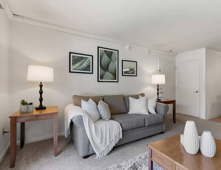A living room with couch and chair East Mountain Apartments