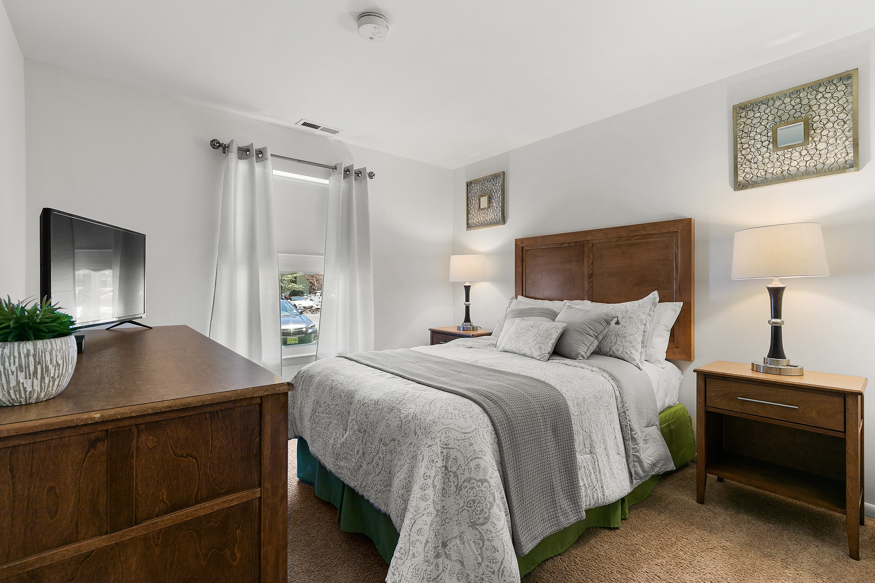 A bedroom with a bed, dresser and television, East Mountain Apartments, Wilkes-Barre, Pennsylvania