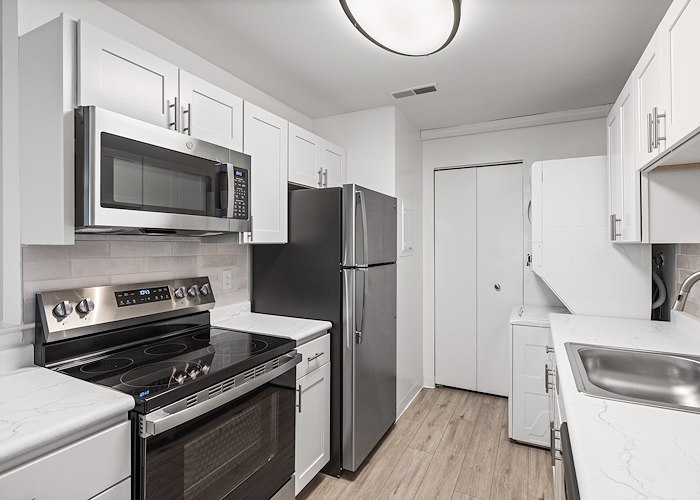 A kitchen with stainless steel appliances and white cabinets, East Mountain Apartments, Wilkes-Barre, Pennsylvania