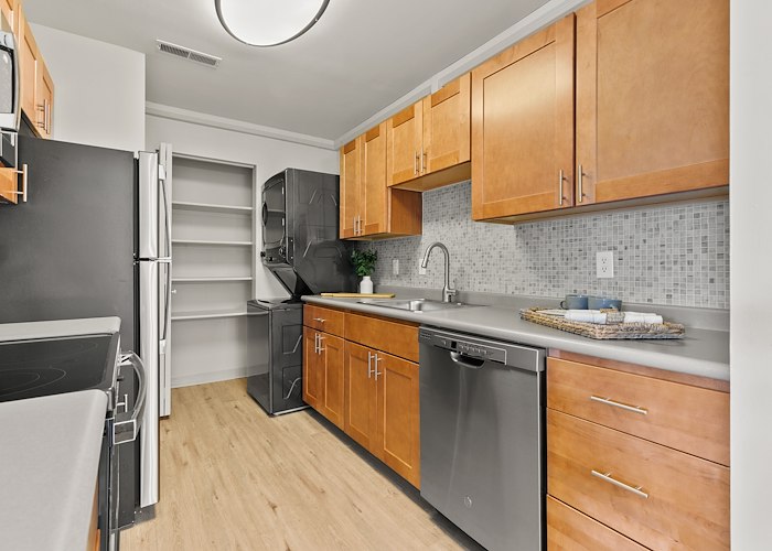 A kitchen with stainless steel appliances and wood cabinets, East Mountain Apartments, Wilkes-Barre, Pennsylvania
