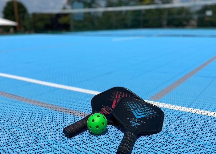 A tennis ball and paddle on a blue court, East Mountain Apartments, Wilkes-Barre, Pennsylvania