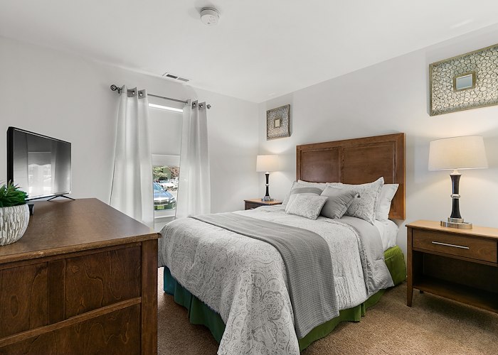 A bedroom with a bed, dresser and television, East Mountain Apartments, Wilkes-Barre, Pennsylvania