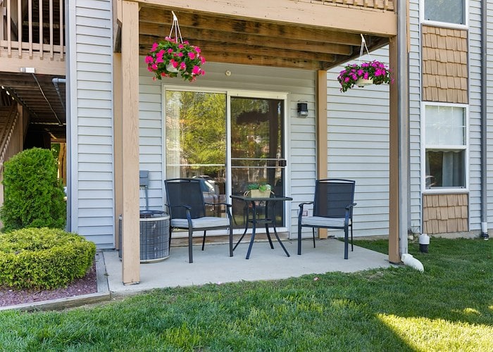 A patio with chairs and a table in front of a house, East Mountain Apartments, Wilkes-Barre, Pennsylvania