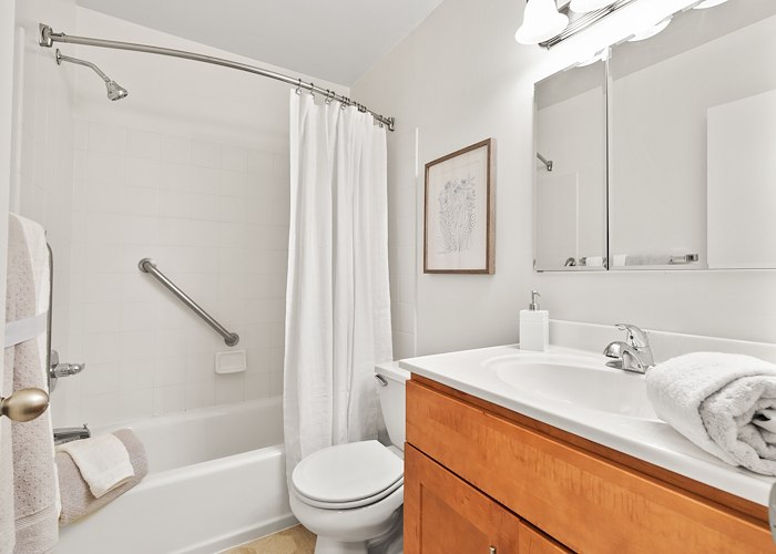 A bathroom with a toilet, sink, and shower at Gateway Apartments in Edwardsville, Pennsylvania