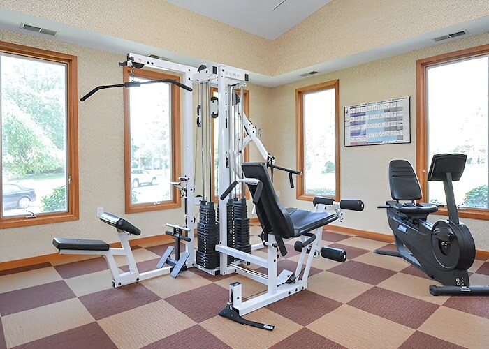 A gym room with exercise equipment and windows at Gateway Apartments in Edwardsville, Pennsylvania