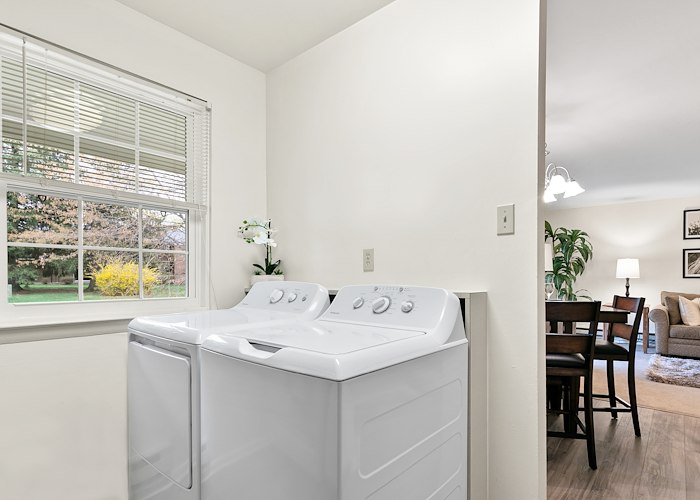 A laundry room with a washer and dryer in it at Gateway Apartments in Edwardsville, Pennsylvania