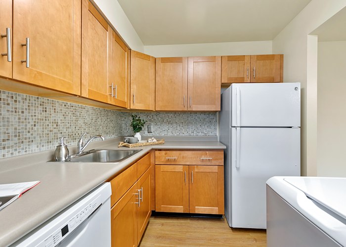 A kitchen with a refrigerator, stove, and sink, Grampian Hills Apartments, Williamsport, Pennsylvania