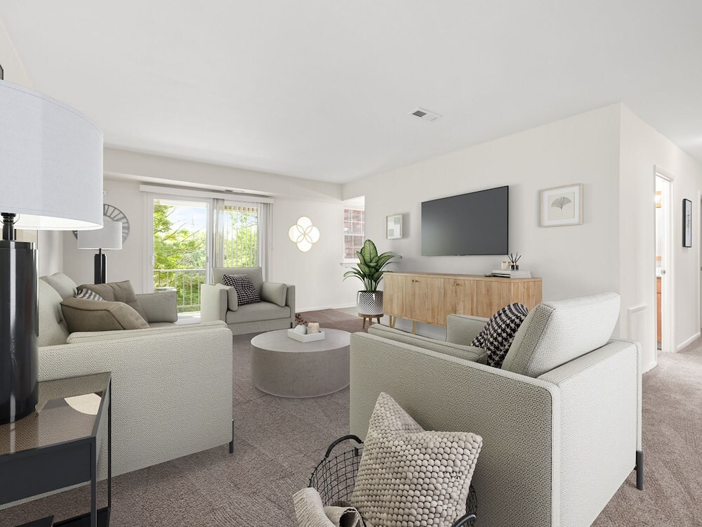Spacious living room at Grampian Hills Apartments featuring sliding-glass doors that lead to a private patio or balcony (Model Furniture Shown).