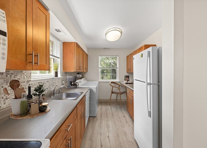 A kitchen with a sink, refrigerator, and microwave, Grampian Hills Apartments, Williamsport, Pennsylvania