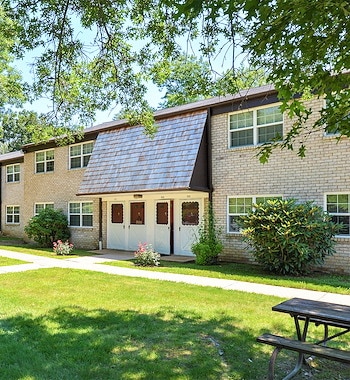 The exterior of an apartment complex with picnic tables, Grampian Hills Apartments, Williamsport, Pennsylvania
