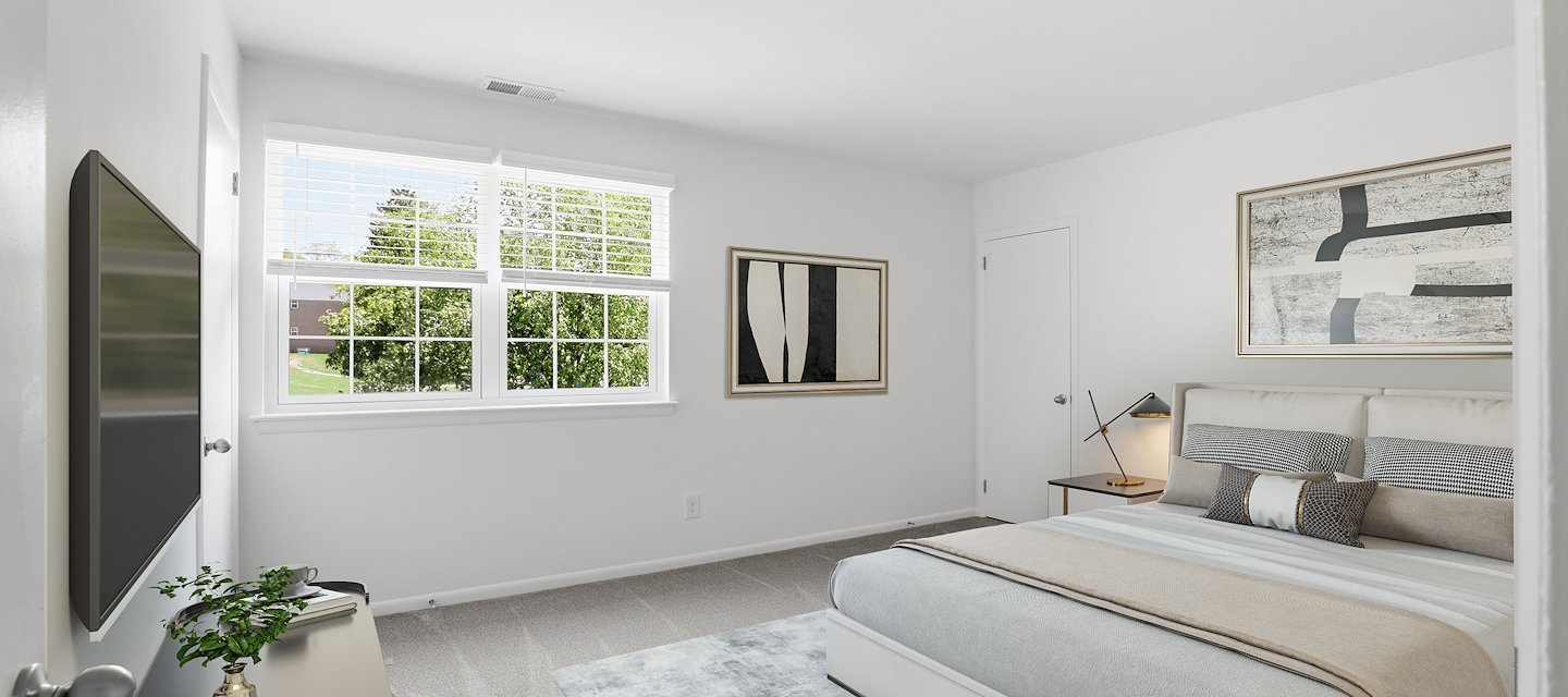 A bedroom with a bed, television and a window, Manor House Apartments, Lancaster, Pennsylvania