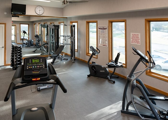 A gym room with exercise equipment and windows, Manor House Apartments, Lancaster, Pennsylvania
