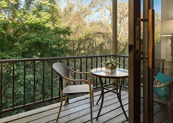 A balcony with a table and chairs overlooking the trees, Pikeview Manor Apartments, Beckley, West Virginia