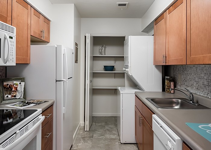 A kitchen with a refrigerator, stove, microwave and sink, Pikeview Manor Apartments, Beckley, West Virginia