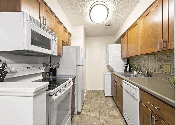 A kitchen with white appliances and wood cabinets, Pikeview Manor Apartments, Beckley, West Virginia