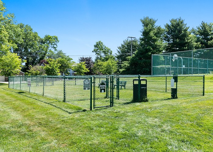 A dog park with a fence and benches, Powder Mill Apartments, York, Pennsylvania