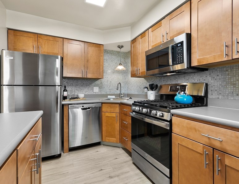 Kitchen with fridge, stove, dishwasher, and microwave at Powder Mill Apartments in York, PA