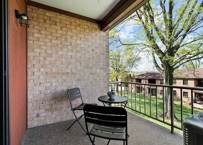 A balcony with chairs and a table overlooking a park, Powder Mill Apartments, York, Pennsylvania