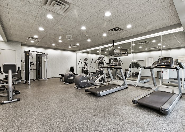A gym room with tread machines and mirrors, Roxalana Apartments, Dunbar, West Virginia