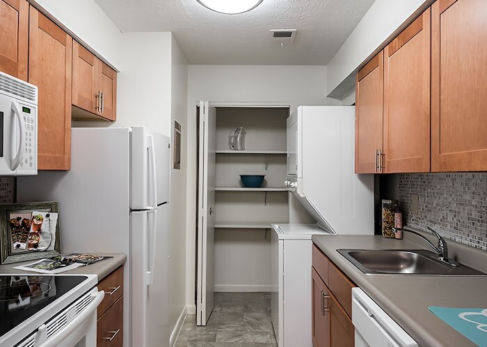 A kitchen with a microwave, refrigerator, and stove, Roxalana Apartments, Dunbar, West Virginia