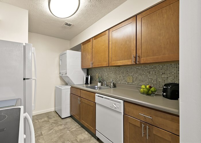 A kitchen with a refrigerator, stove, and microwave, Roxalana Apartments, Dunbar, West Virginia