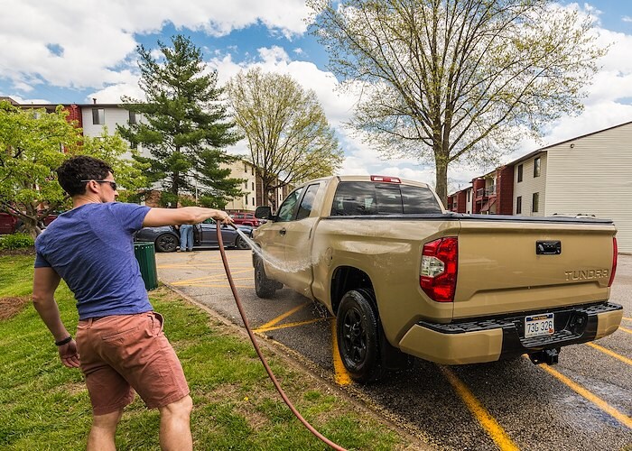 A man is washing his truck, Roxalana Apartments, Dunbar, West Virginia
